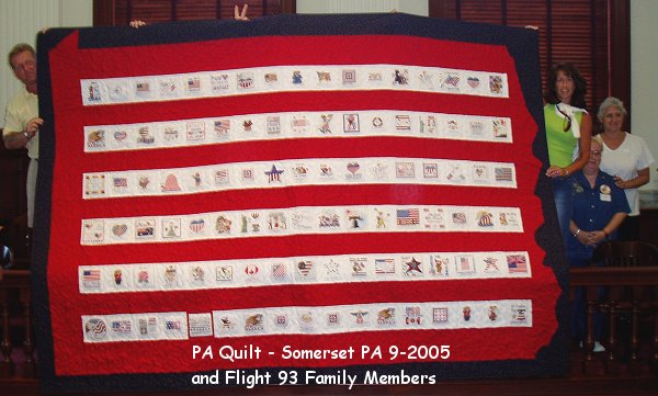 The Pennsylvania quilt, shaped like the state, held up in the Somerset County courthouse