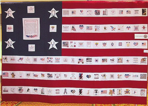 The FDNY quilt: the letters F, D, N and Y on stars around a framed panel in the blue corner